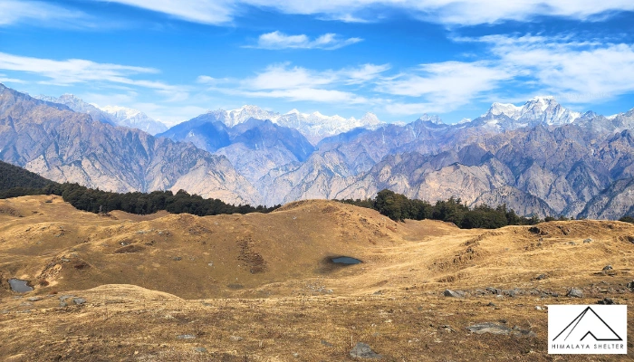 Walking across Kuari Pass&rsquo;s rolling alpine meadows towards the snow-clad peaks