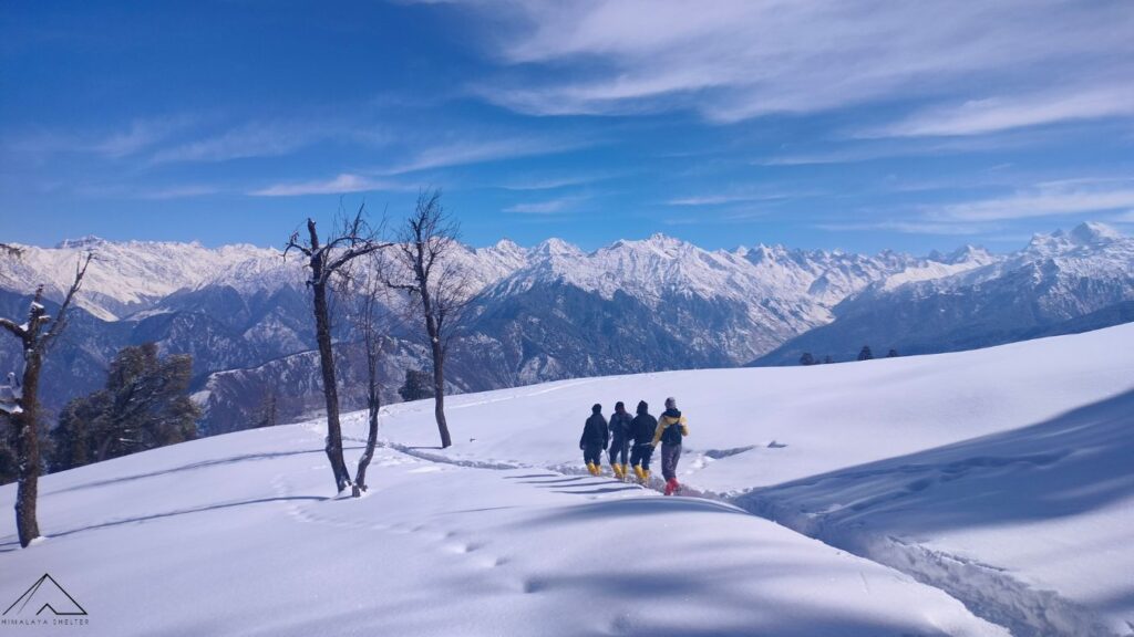 snow covered landscape while descending from Kedarkantha Peak in Winter